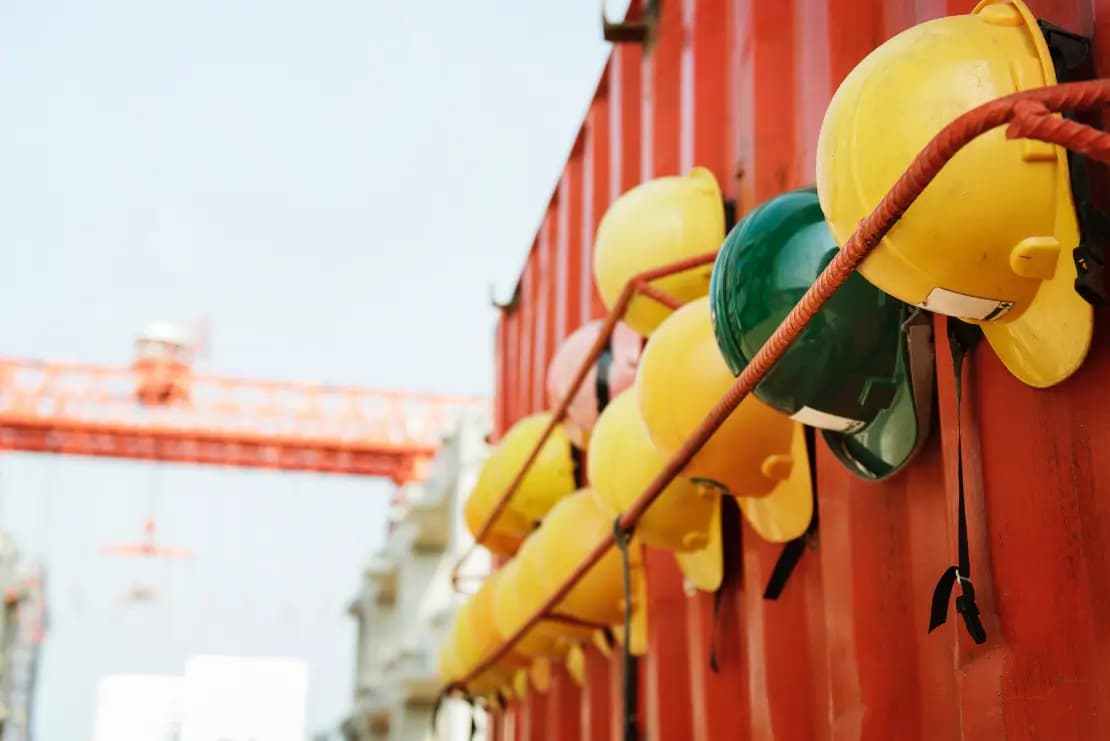 Construction workers wearing hard hats at a building site